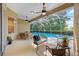 View of screened patio with seating area and dining set, overlooking the pool area at 10751 Tavistock Dr, Tampa, FL 33626