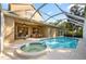 Relaxing screened-in pool and spa with an attached dining area and views of the home's exterior at 10751 Tavistock Dr, Tampa, FL 33626