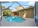 Relaxing screened-in pool with an attached spa, outside dining area, and views of the home's exterior at 10751 Tavistock Dr, Tampa, FL 33626