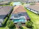 Aerial view of a private pool and screened-in patio with lake and neighborhood views at 11039 Calluna Dr, Odessa, FL 33556