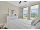 Bedroom featuring large windows, natural light, and a ceiling fan at 11039 Calluna Dr, Odessa, FL 33556