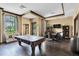 Billiard room with pool table, chairs, and entertainment features at 11039 Calluna Dr, Odessa, FL 33556