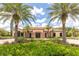 Exterior of clubhouse framed by palm trees and lush greenery in a well-maintained setting at 11039 Calluna Dr, Odessa, FL 33556