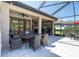 Spacious outdoor dining and seating area with ceiling fans and seamless indoor-outdoor flow at 11039 Calluna Dr, Odessa, FL 33556