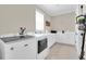 Bright laundry room with modern washer/dryer and storage cabinets at 11039 Calluna Dr, Odessa, FL 33556
