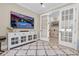 Living room featuring access to the office and a view of the pool on TV at 11039 Calluna Dr, Odessa, FL 33556