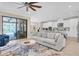 Bright open concept living room featuring modern decor and sliding glass doors to the pool area at 11039 Calluna Dr, Odessa, FL 33556