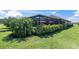 Screened-in patio with palm trees and lush landscaping at 11039 Calluna Dr, Odessa, FL 33556