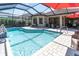 Sparkling screened-in pool with ample seating and a relaxing outdoor space at 11039 Calluna Dr, Odessa, FL 33556