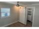 Bedroom with wood-look floors, a fan, and a closet with a sliding door and built-in shelving at 11110 1St E St, Treasure Island, FL 33706
