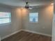 Clean and bright bedroom featuring wood-look floors, neutral walls, and two windows for natural light at 11110 1St E St, Treasure Island, FL 33706