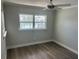 Simple bedroom features neutral walls, wood-look floors, and a window overlooking a canal at 11110 1St E St, Treasure Island, FL 33706