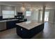 Modern kitchen with a large island, stainless steel appliances, and stylish pendant lighting at 11110 1St E St, Treasure Island, FL 33706