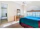 Sunlit bedroom featuring a bed, dresser, ceiling fan, and a window at 11620 Eastern Star Ct, New Port Richey, FL 34654