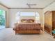 Bedroom featuring a bed, lamps, ceiling fan, and a sliding glass door at 11620 Eastern Star Ct, New Port Richey, FL 34654