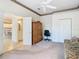 Bedroom with a view of a kitchenette, ceiling fan, closet, and furniture at 11620 Eastern Star Ct, New Port Richey, FL 34654