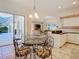 Bright eat-in kitchen with a glass table and chairs, with an adjacent living room at 11620 Eastern Star Ct, New Port Richey, FL 34654