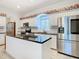 Modern kitchen featuring stainless steel appliances and granite countertops at 11620 Eastern Star Ct, New Port Richey, FL 34654