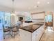 Open-concept kitchen and breakfast nook with modern appliances and ample counter space at 11620 Eastern Star Ct, New Port Richey, FL 34654
