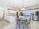 Modern eat-in kitchen featuring stainless steel appliances and an ornate table at 11620 Eastern Star Ct, New Port Richey, FL 34654
