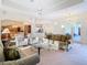 Bright, open-concept living room featuring high ceilings and seamless flow to the dining area at 11620 Eastern Star Ct, New Port Richey, FL 34654