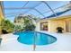 Inviting pool with screen enclosure and lush landscaping at 11620 Eastern Star Ct, New Port Richey, FL 34654