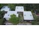 A view of buildings with trees and foliage, and cars parked below at 11705 Raintree Village Blvd # C, Temple Terrace, FL 33617
