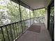 View of condo balcony surrounded by lush landscaping and trees at 11705 Raintree Village Blvd # C, Temple Terrace, FL 33617