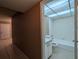 Bathroom adjacent to hallway featuring a tub, shower, toilet, and sink at 11705 Raintree Village Blvd # C, Temple Terrace, FL 33617