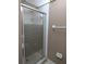 Bathroom shower featuring white tiles and a sliding door with chrome fixtures at 11705 Raintree Village Blvd # C, Temple Terrace, FL 33617