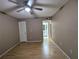 Bedroom featuring hardwood floors and ceiling fan plus a closet and bathroom entrance at 11705 Raintree Village Blvd # C, Temple Terrace, FL 33617