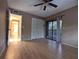 Bedroom featuring hardwood floors, fan and sliding doors to screened porch at 11705 Raintree Village Blvd # C, Temple Terrace, FL 33617