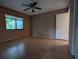 Bedroom features a fan, light hardwood floors and a view from a large window at 11705 Raintree Village Blvd # C, Temple Terrace, FL 33617