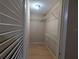 Walk-in closet with installed racks on the wall and wood flooring at 11705 Raintree Village Blvd # C, Temple Terrace, FL 33617