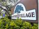An eye-level view of the community sign for Raintree Village at 11705 Raintree Village Blvd # C, Temple Terrace, FL 33617