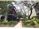 A condo featuring a screened balcony surrounded by lush landscaping at 11705 Raintree Village Blvd # C, Temple Terrace, FL 33617