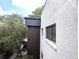 View of the exterior featuring tan stucco walls, and windows at 11705 Raintree Village Blvd # C, Temple Terrace, FL 33617