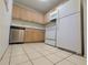 An open kitchen area featuring laminate countertops, appliances, and cabinetry at 11705 Raintree Village Blvd # C, Temple Terrace, FL 33617