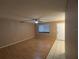 A comfortable living room has neutral walls, a ceiling fan and tiled entryway at 11705 Raintree Village Blvd # C, Temple Terrace, FL 33617