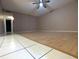 A bright room with hardwood flooring, a ceiling fan and neutral paint at 11705 Raintree Village Blvd # C, Temple Terrace, FL 33617