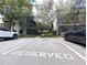 Reserved parking space in front of a pair of buildings with lush trees at 11705 Raintree Village Blvd # C, Temple Terrace, FL 33617