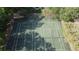Aerial view of two well-maintained tennis courts surrounded by lush trees at 11705 Raintree Village Blvd # C, Temple Terrace, FL 33617