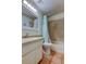 Bathroom featuring a shower-tub combination, blue shower curtain, sink with vanity, and tile flooring at 12004 Plantain Ct, Tampa, FL 33635