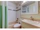 Bathroom featuring tiled walls, shower with tub, and a vanity with sink at 12004 Plantain Ct, Tampa, FL 33635