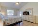 Inviting bedroom with tiled flooring, ceiling fan, and dresser with mirror at 12004 Plantain Ct, Tampa, FL 33635
