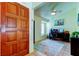Inviting office space with a dark wood door, ceiling fan, and arched window at 12004 Plantain Ct, Tampa, FL 33635