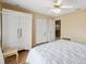 Bedroom with hardwood floors, an armoire, a closet, and neutral colored walls at 13238 Asbury St, Spring Hill, FL 34609