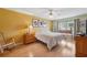 Cozy bedroom with a ceiling fan, wood floors, and natural light at 13238 Asbury St, Spring Hill, FL 34609