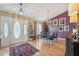 Elegant dining room features a modern chandelier, stylish decor, and a colorful area rug on hardwood floors at 13238 Asbury St, Spring Hill, FL 34609