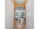 Hallway view leading into a bedroom with hardwood floors and a ceiling fan at 13238 Asbury St, Spring Hill, FL 34609
